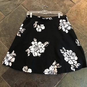 Black skirt with white flowers the skirt does have a few thread pulls
